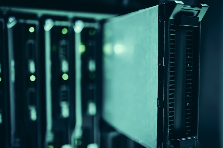 Close-up of server units in a rack with green status lights