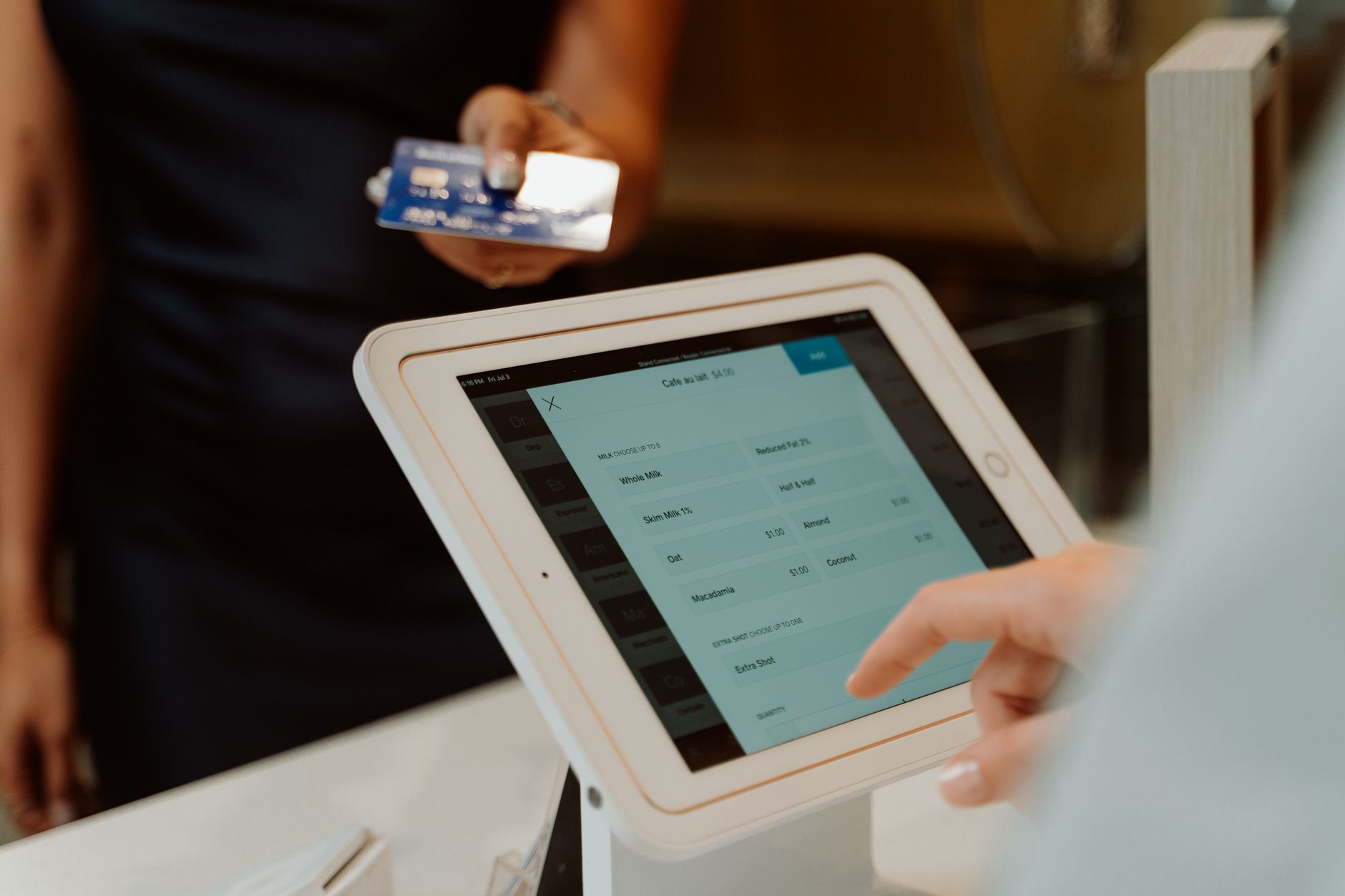 A tablet on a counter stand with a card reader